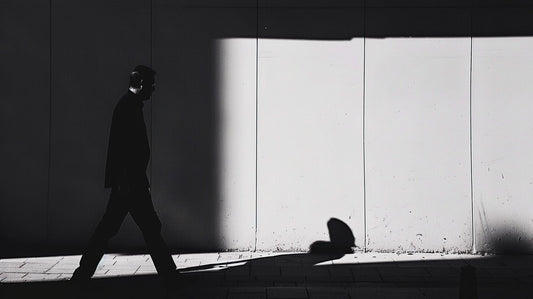 Silhouetted man walking through shadow, symbolizing AI disillusionment phase.