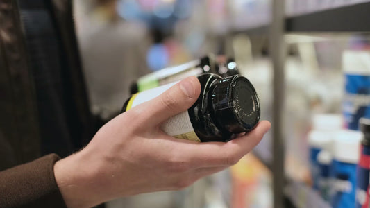 Person holding supplement bottles in a store aisle, representing Academic Supplements and Herbs Health Guide Free - ChatGPT Personal AI software tool.