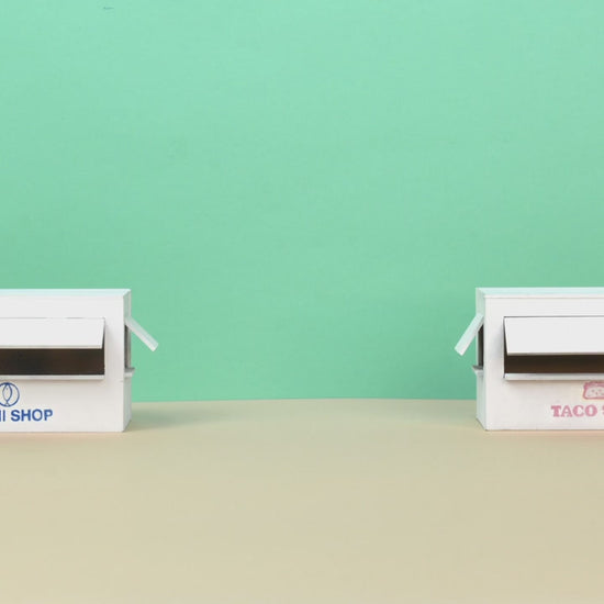 Looka AI Logo and Brand Design - Custom Platform (Paid) Business AI showcasing minimalist branding for Sushi Shop and Taco Shop on white storefront models.