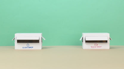 Looka AI Logo and Brand Design - Custom Platform (Paid) Business AI showcasing minimalist branding for Sushi Shop and Taco Shop on white storefront models.